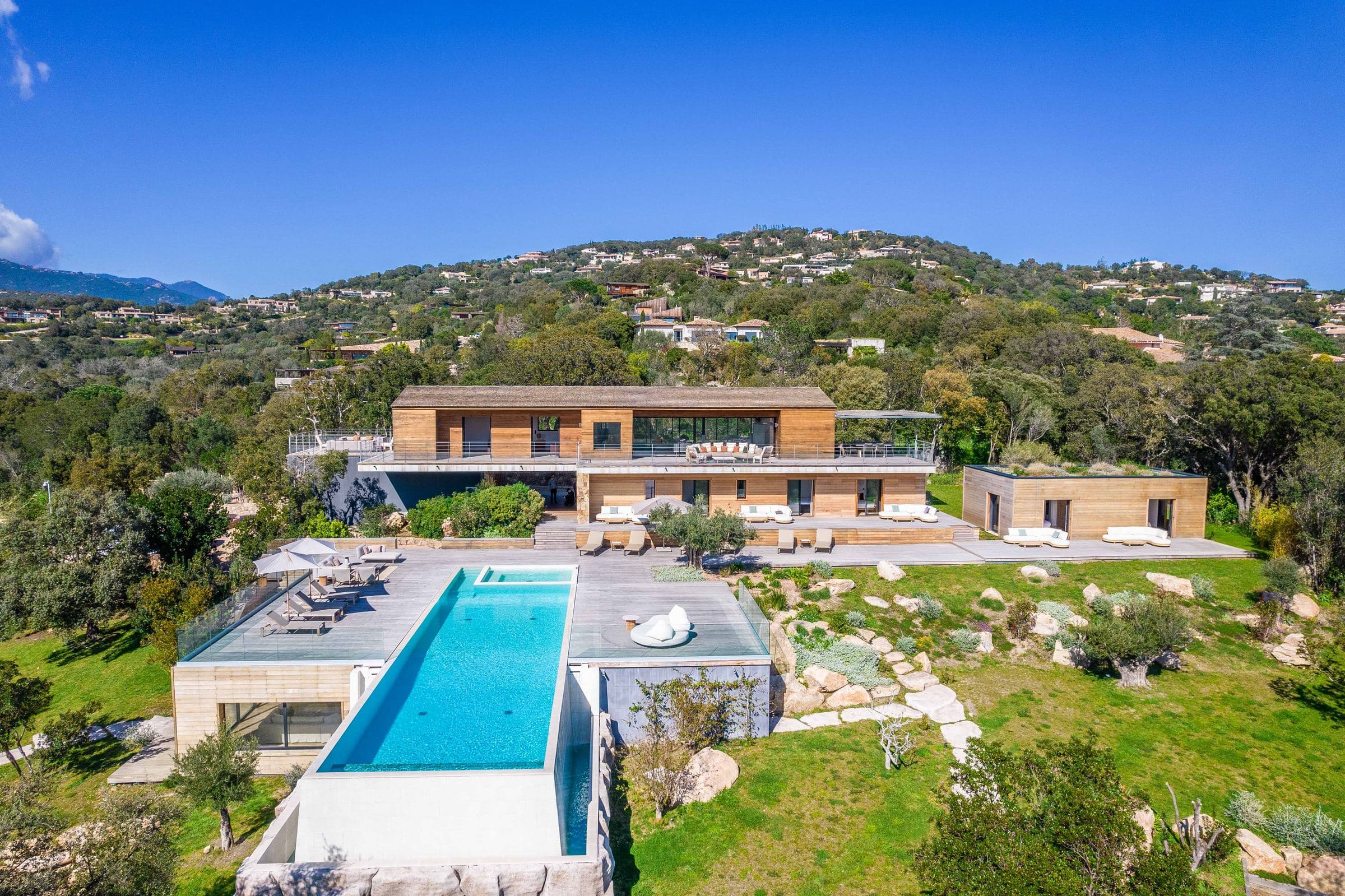 Aerial view over the olive grove and pool