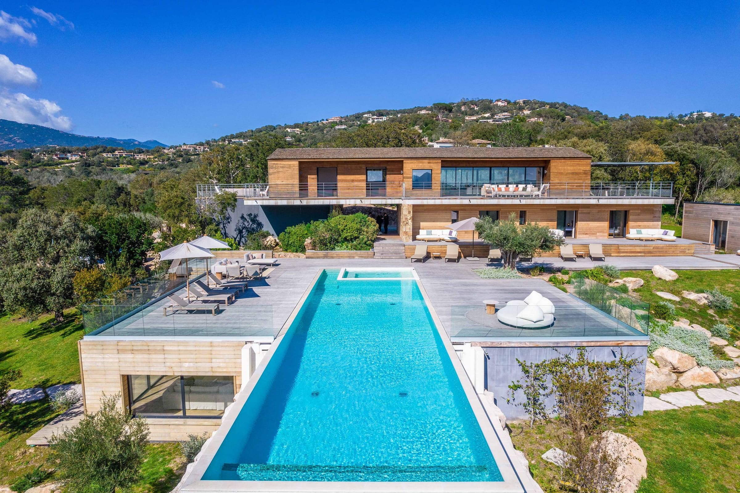 Aerial view of Villa Legna, its pool and terraces facing the mountains